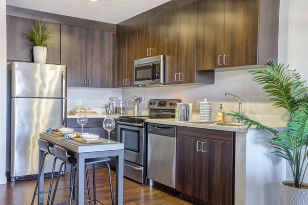 Modern kitchen with sleek countertops and stainless steel appliances at Vara Apartments