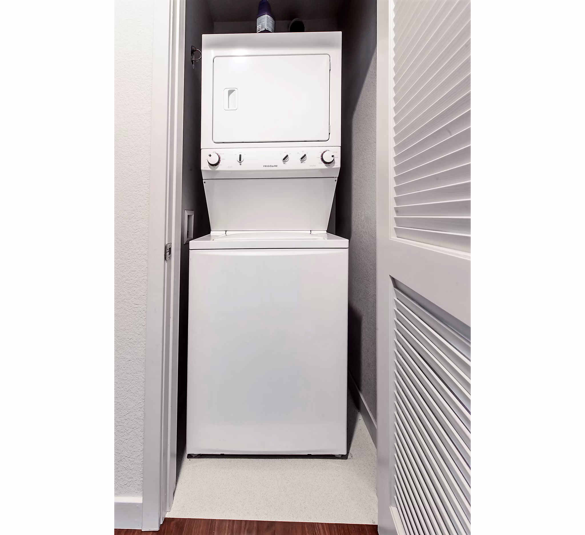 Stacked washer and dryer unit in a modern luxury apartment