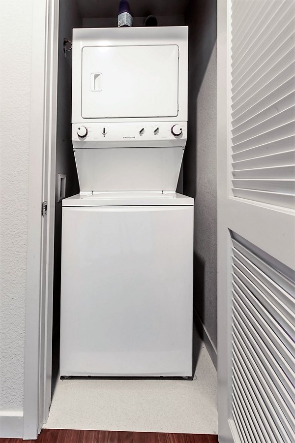 Stacked washer and dryer unit in a modern luxury apartment