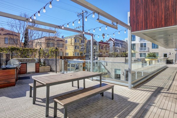 Modern outdoor grill area at Vara Apartments featuring sleek stainless steel grills and spacious seating for social gatherings and relaxing