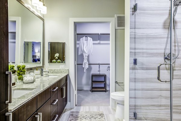 Spacious modern bathroom with elegant tiling at Overture Arboretum Apartments suitable for luxury living