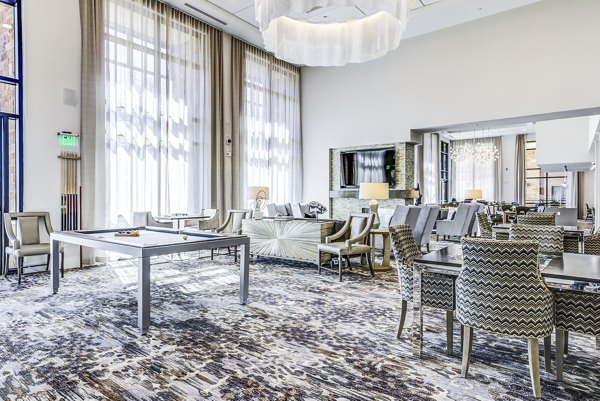 Clubhouse game room with billiards and lounge seating at Overture Arboretum Apartments, offering luxury living for active adults