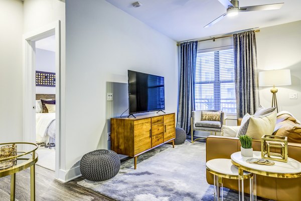 Spacious living room with modern decor and natural light in Overture Arboretum Apartments