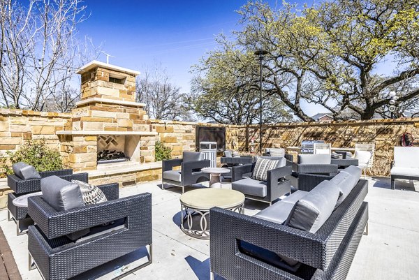 Fire pit and patio area with seating at Overture Arboretum Apartments, ideal for outdoor relaxation and gatherings