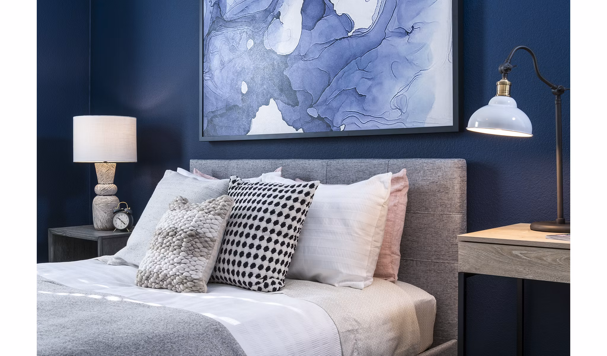 Cozy bedroom featuring rich wooden furniture at Baileys Crossing luxury apartments
