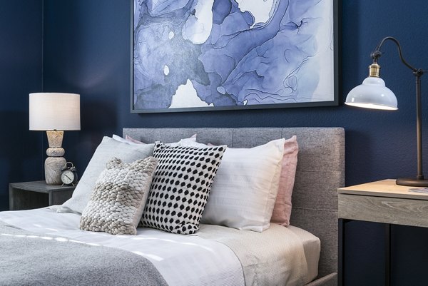 Cozy bedroom featuring rich wooden furniture at Baileys Crossing luxury apartments