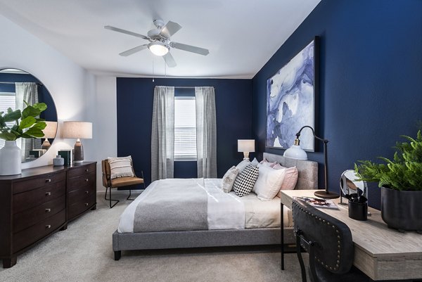 Comfortable bedroom featuring modern decor in Baileys Crossing apartments, renovated in 2018