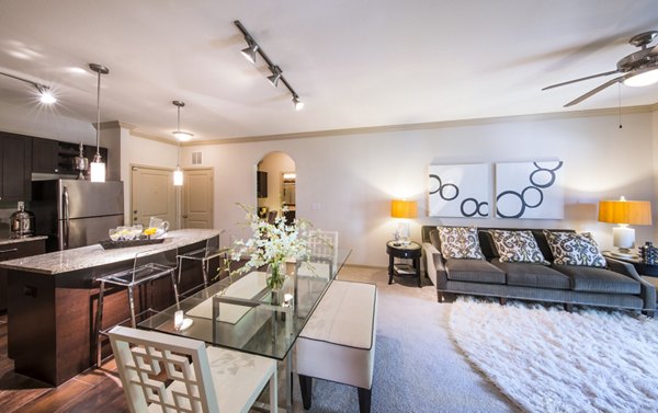 Cozy living room with plush seating and a large window in Bailey's Crossing Apartments