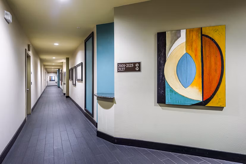 Spacious hallway with modern lighting at Allegro Apartments