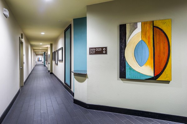 Spacious hallway with modern lighting at Allegro Apartments