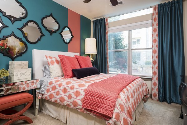 Elegant bedroom with plush bedding and modern decor at Allegro Apartments
