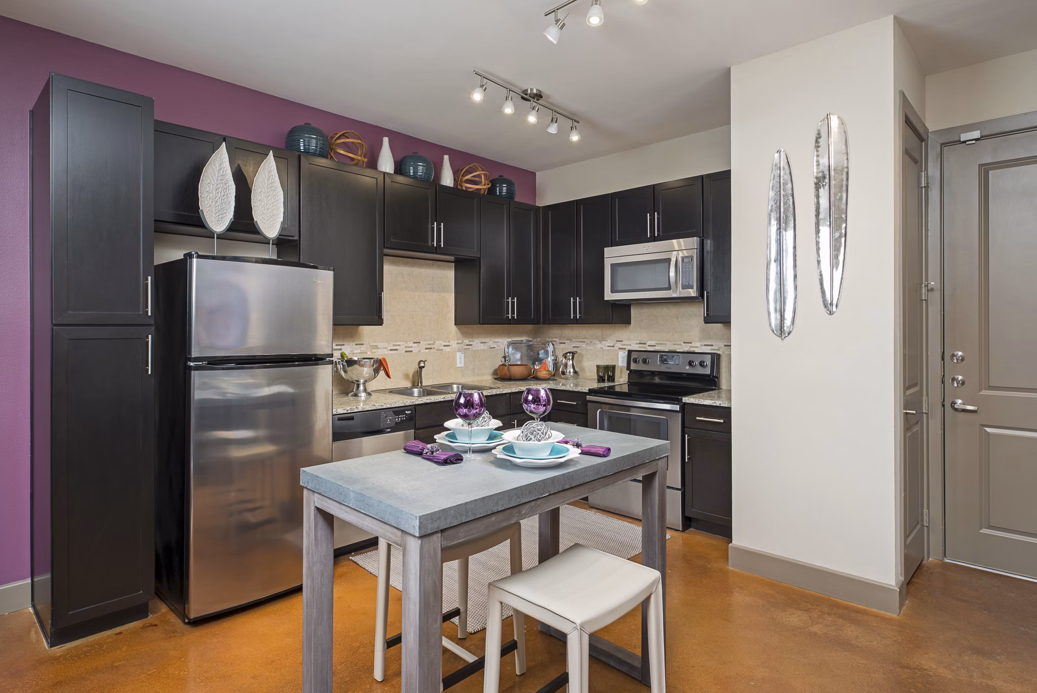 Modern kitchen with stainless steel appliances and granite countertops in Allegro Apartments