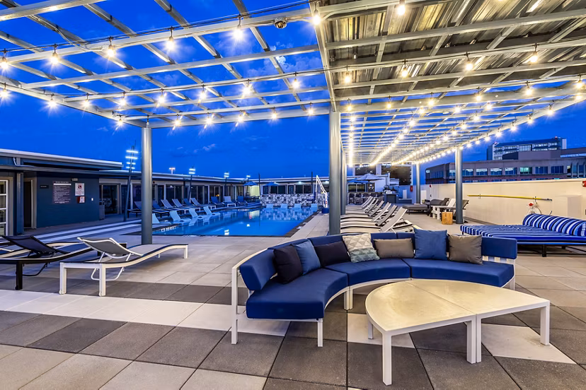 Allegro Apartments: Modern pool patio featuring lounge seating and landscaped surroundings