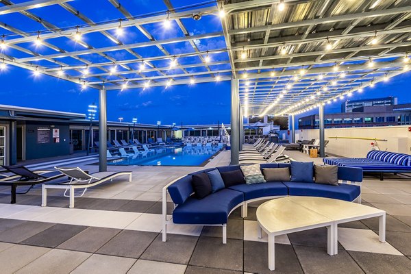Allegro Apartments: Modern pool patio featuring lounge seating and landscaped surroundings