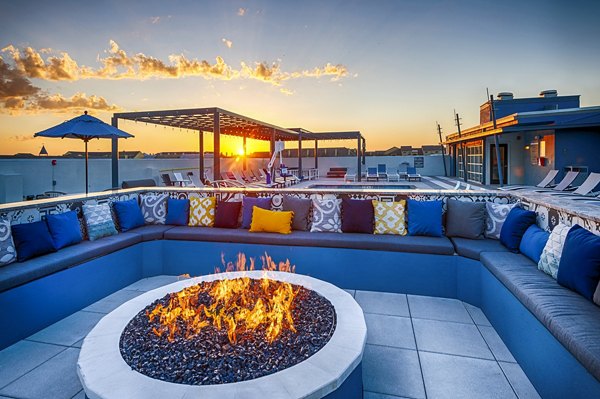 fire pit with seating area at Allegro Apartments, a luxury Greystar property