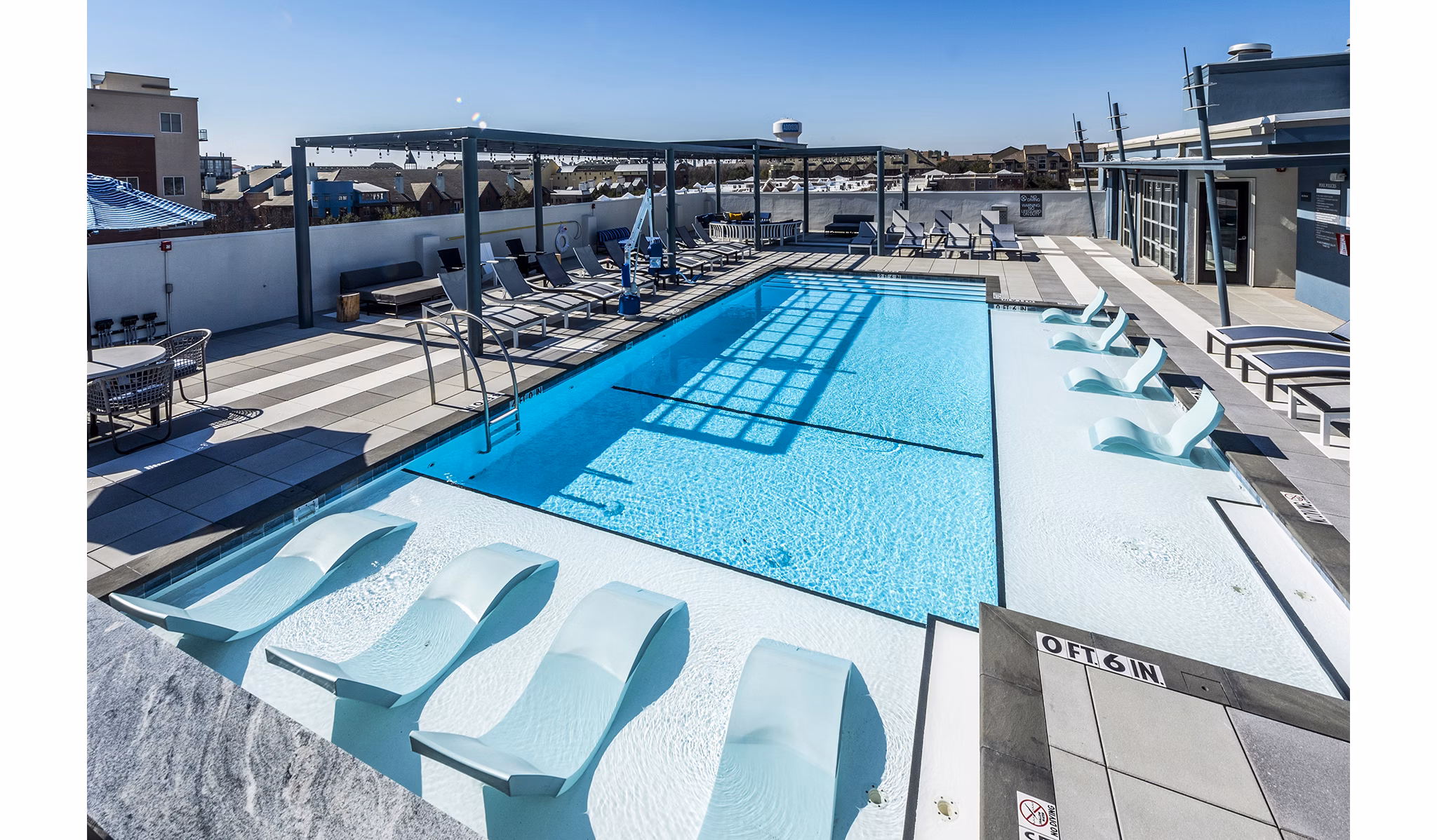 Allegro Apartments: Stunning resort-style pool area with lounge chairs and greenery in a serene setting
