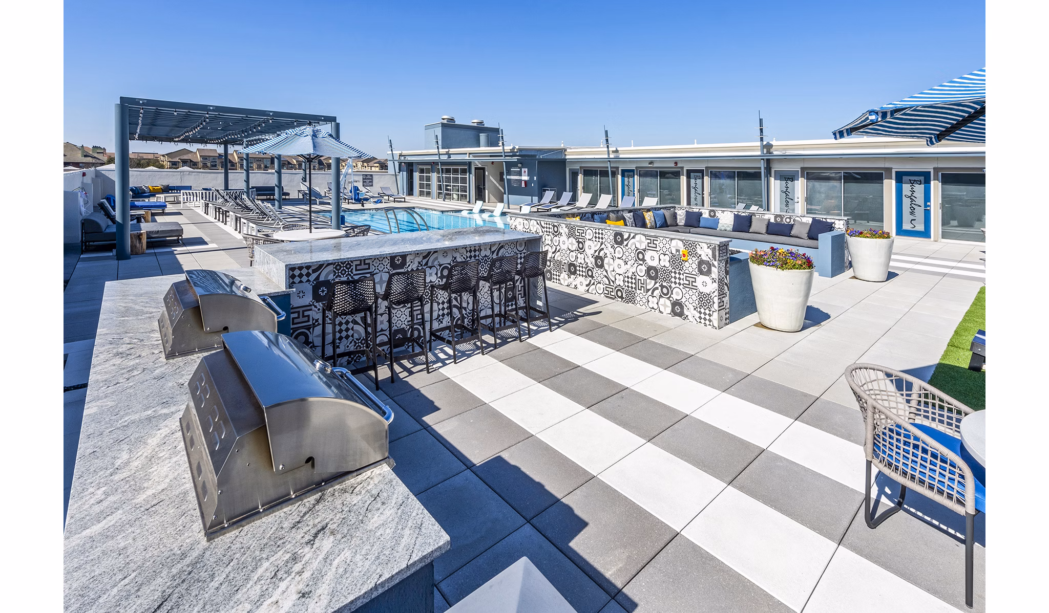Outdoor barbecue area with modern grills at Allegro Apartments, Greystar luxury community