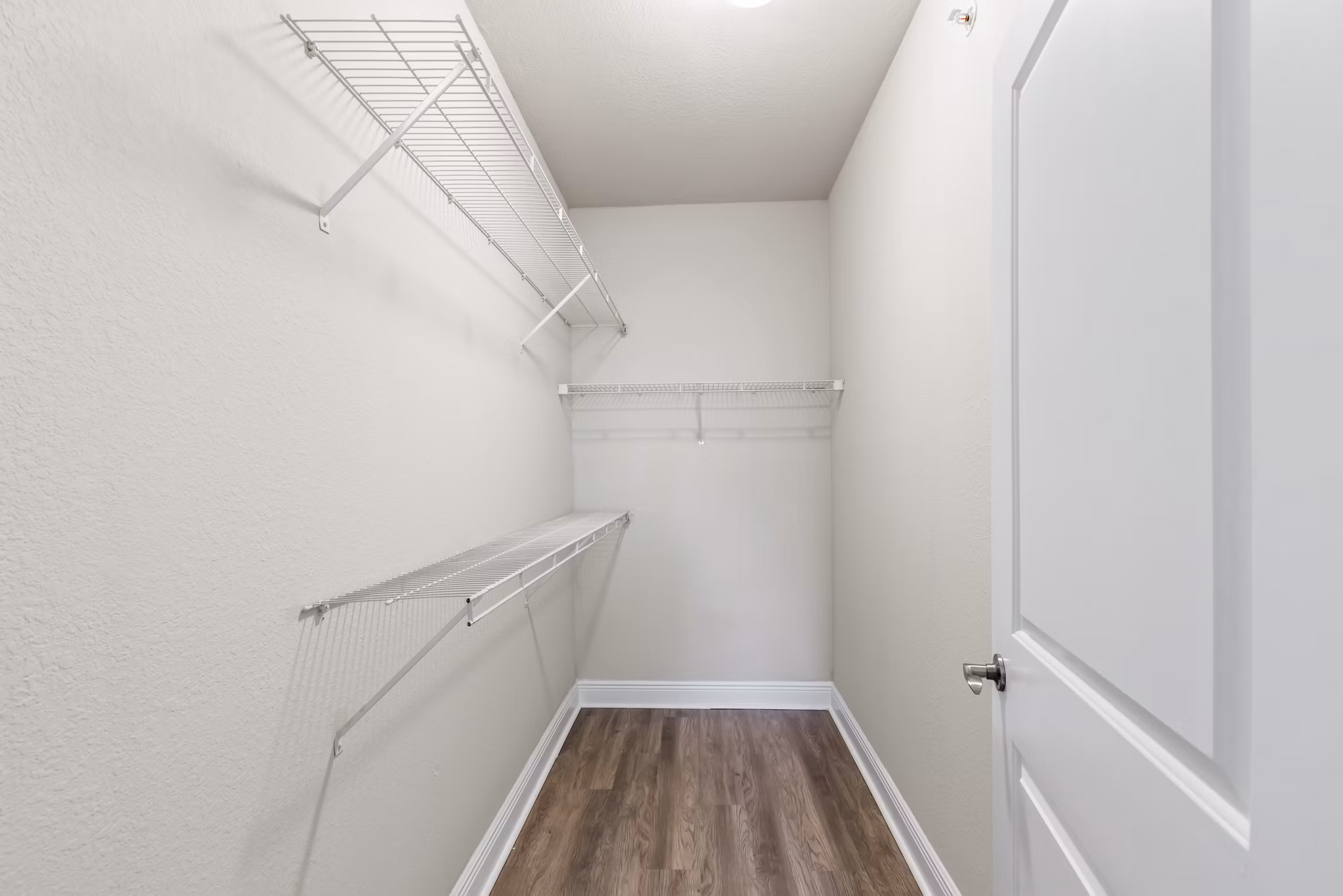 Bedroom closet with built-in organizers at SoMa at Brickell Apartments