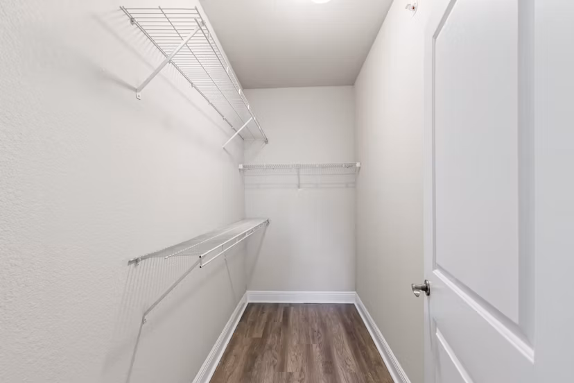 Bedroom closet with built-in organizers at SoMa at Brickell Apartments