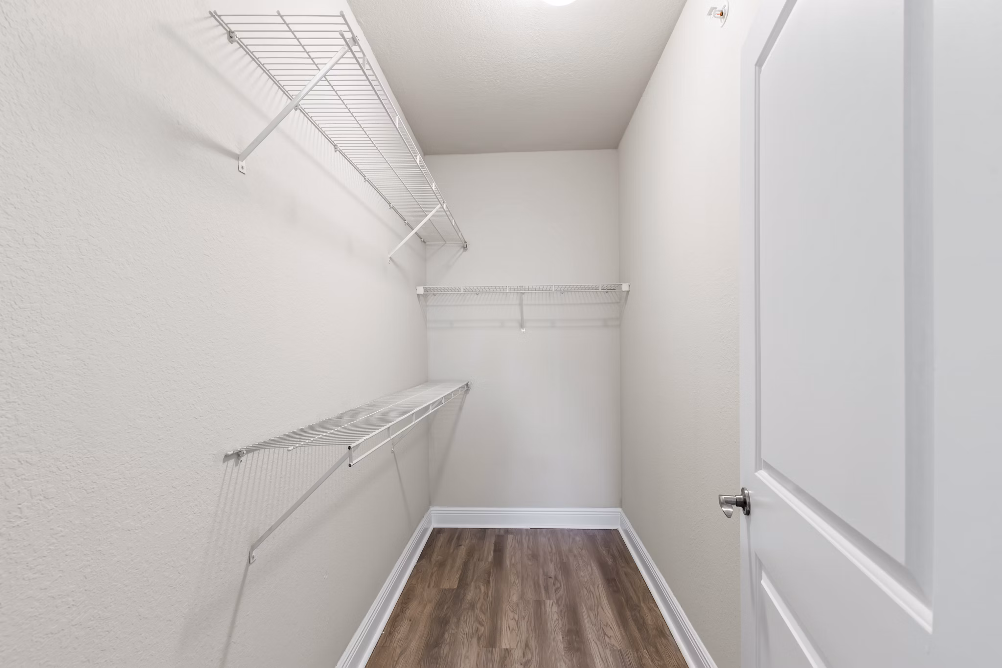 Bedroom closet with built-in organizers at SoMa at Brickell Apartments