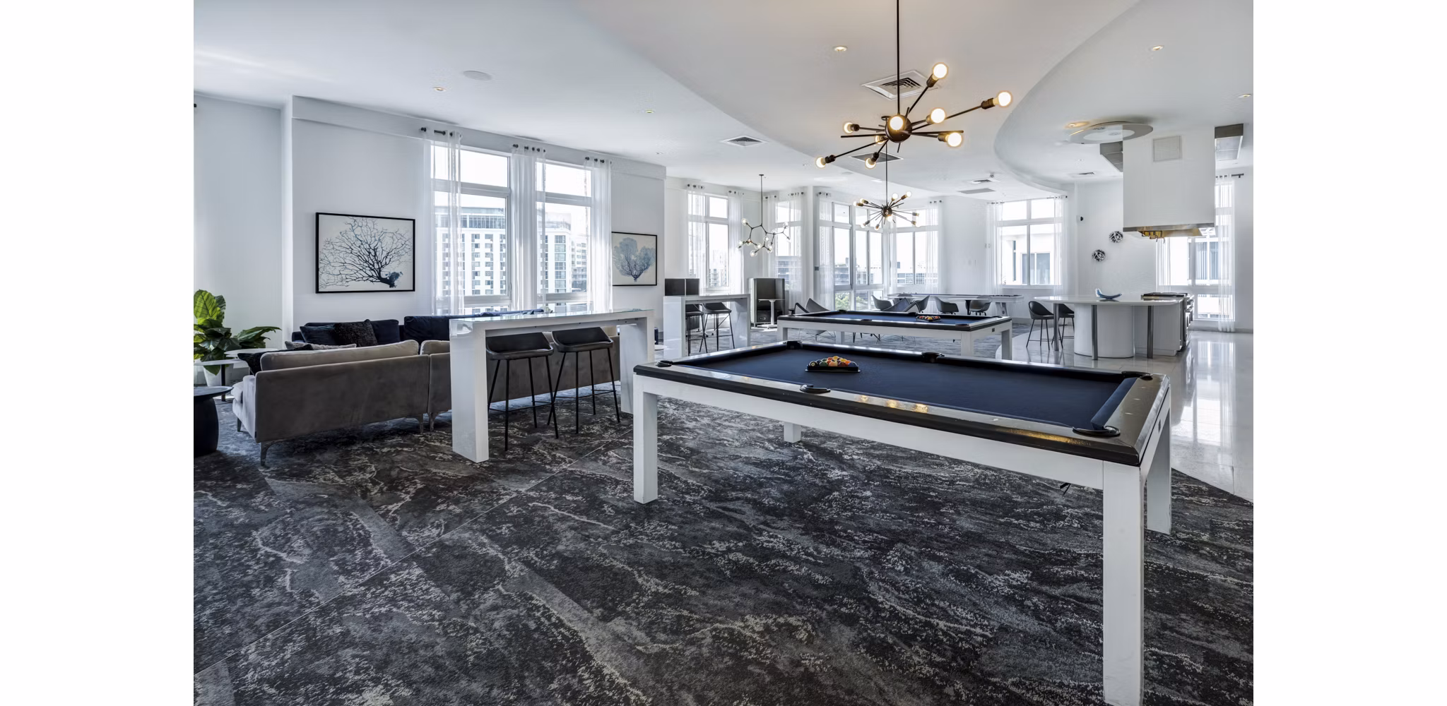 Modern clubhouse with stylish decor at SoMa at Brickell Apartments, featuring luxurious seating and entertainment areas