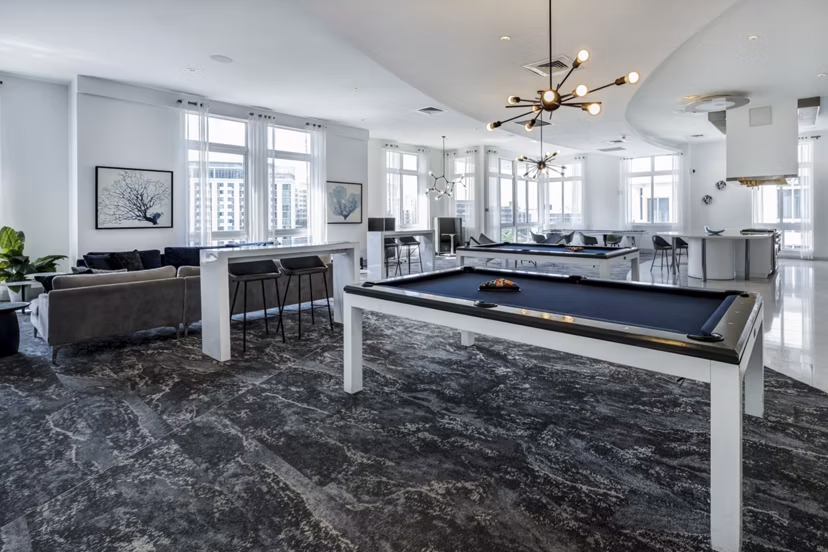 Modern clubhouse with stylish decor at SoMa at Brickell Apartments, featuring luxurious seating and entertainment areas