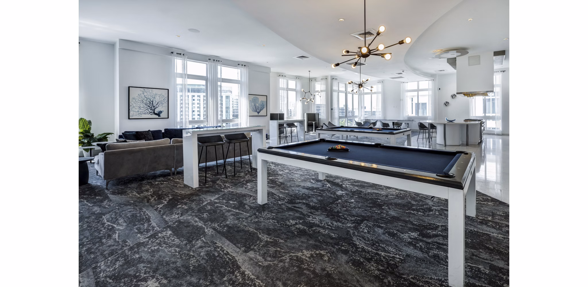 Modern clubhouse with stylish decor at SoMa at Brickell Apartments, featuring luxurious seating and entertainment areas