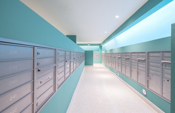 Modern mail room featuring secure package lockers at SoMa at Brickell Apartments