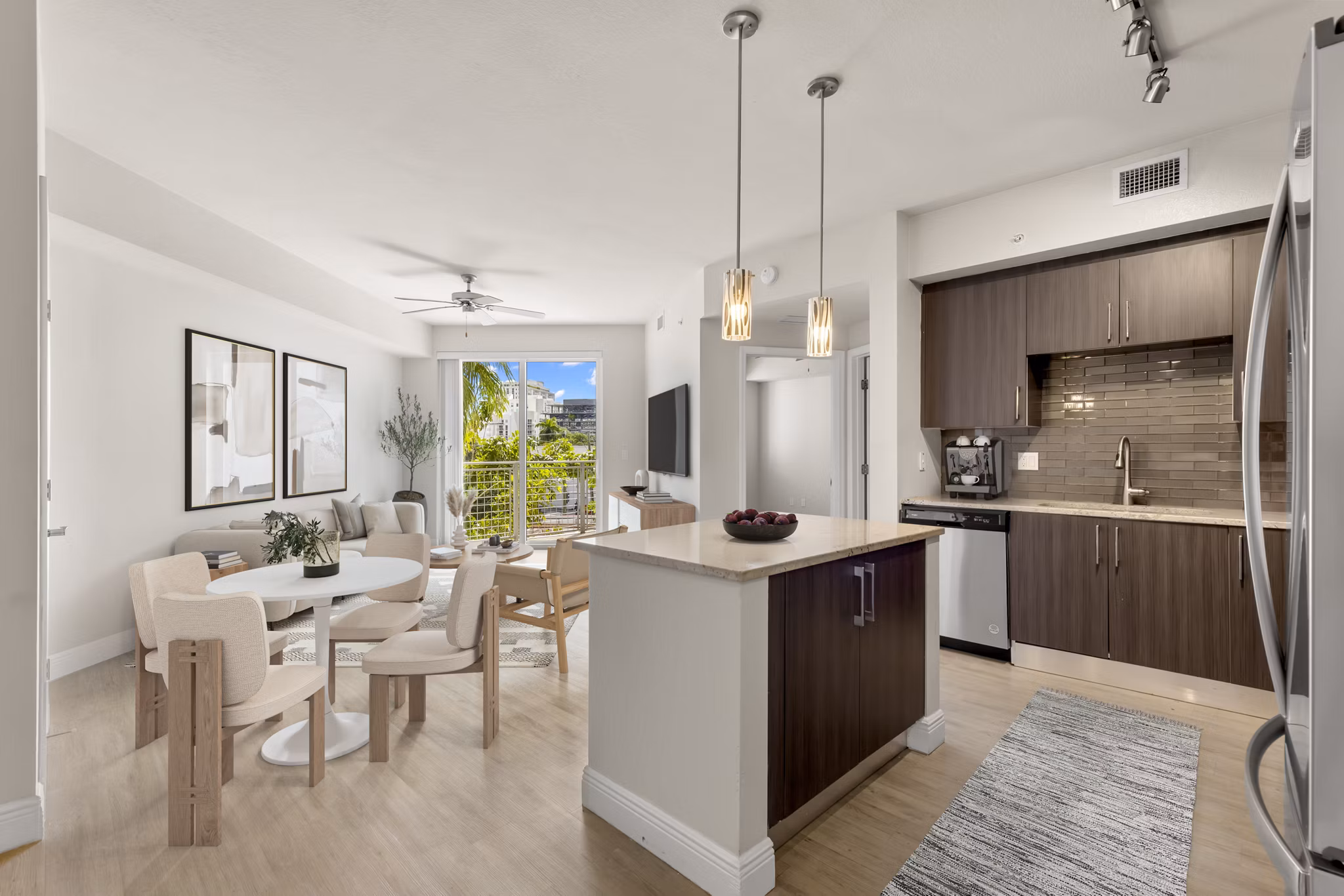 Open-plan kitchen with sleek countertops and modern appliances in SoMa at Brickell Apartments