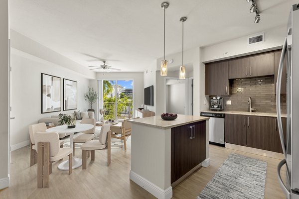 Open-plan kitchen with sleek countertops and modern appliances in SoMa at Brickell Apartments