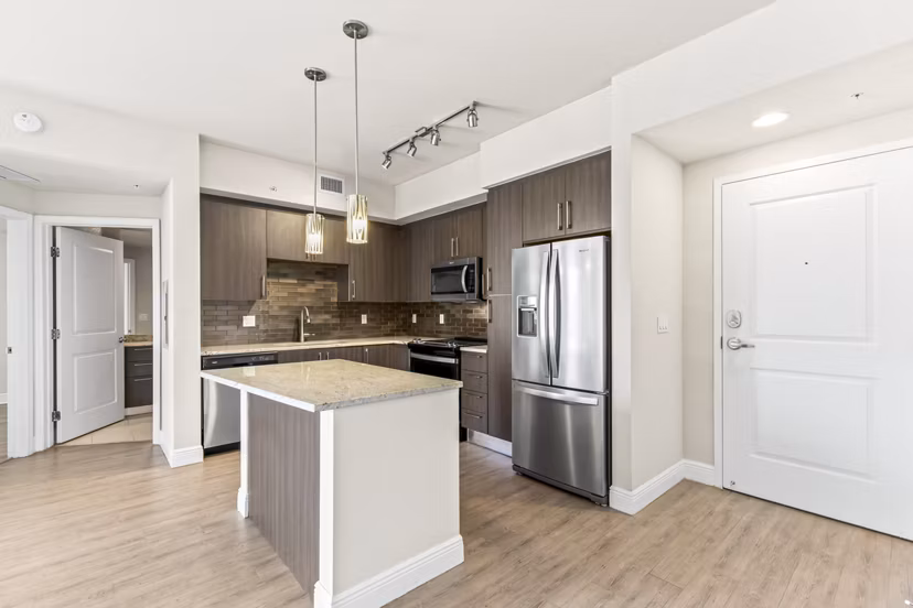 Spacious kitchen with stainless steel appliances at SoMa at Brickell Apartments, luxury living in the heart of Miami