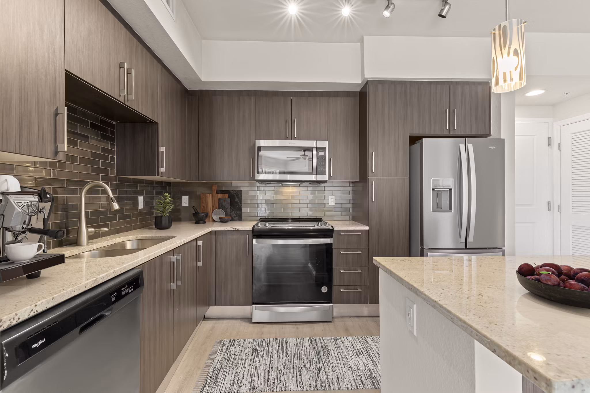 Modern kitchen with stainless steel appliances at SoMa at Brickell Apartments