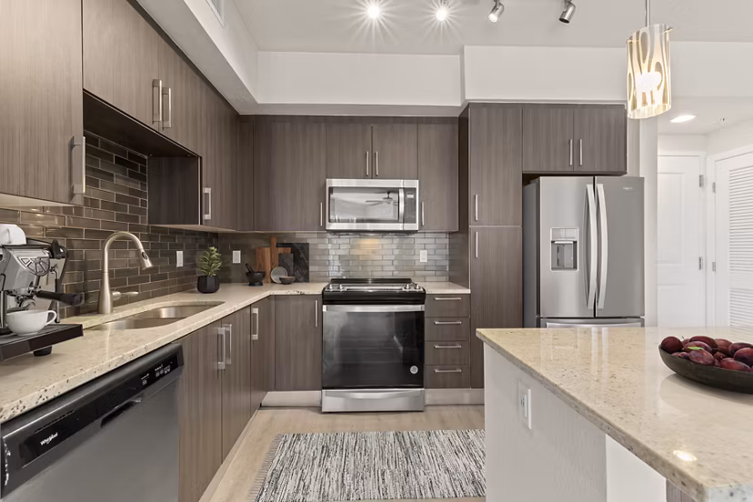 Modern kitchen with stainless steel appliances at SoMa at Brickell Apartments