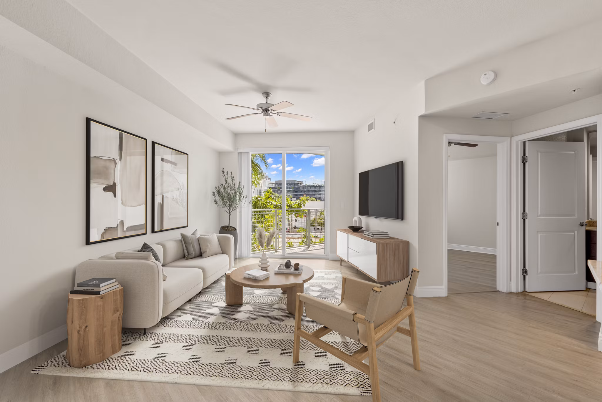 Living room with elegant decor and natural light at SoMa at Brickell Apartments