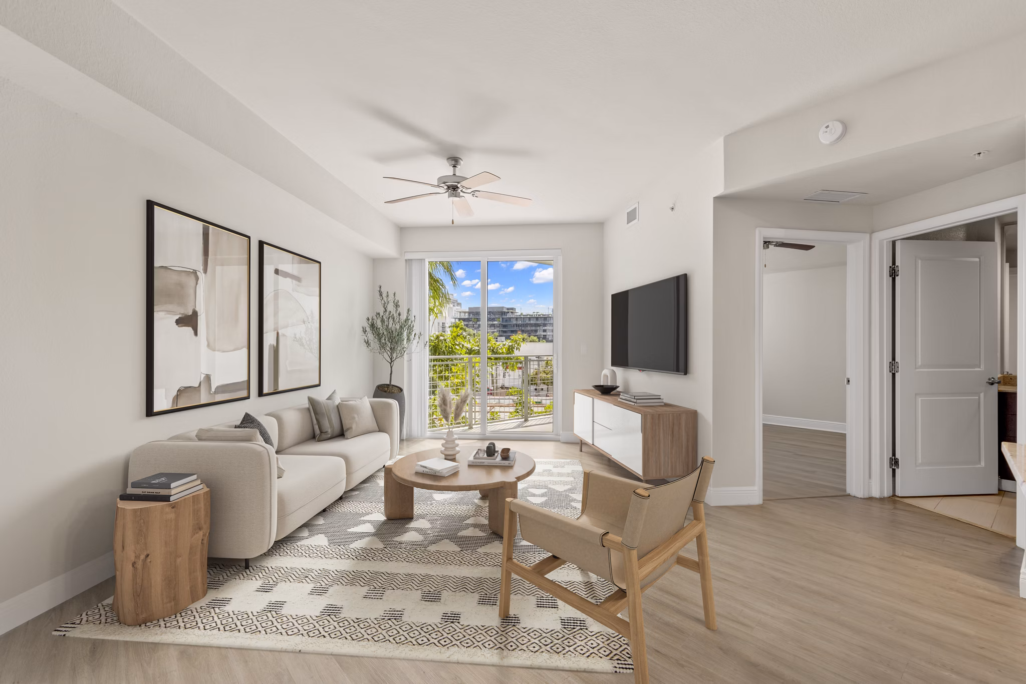Living room with elegant decor and natural light at SoMa at Brickell Apartments