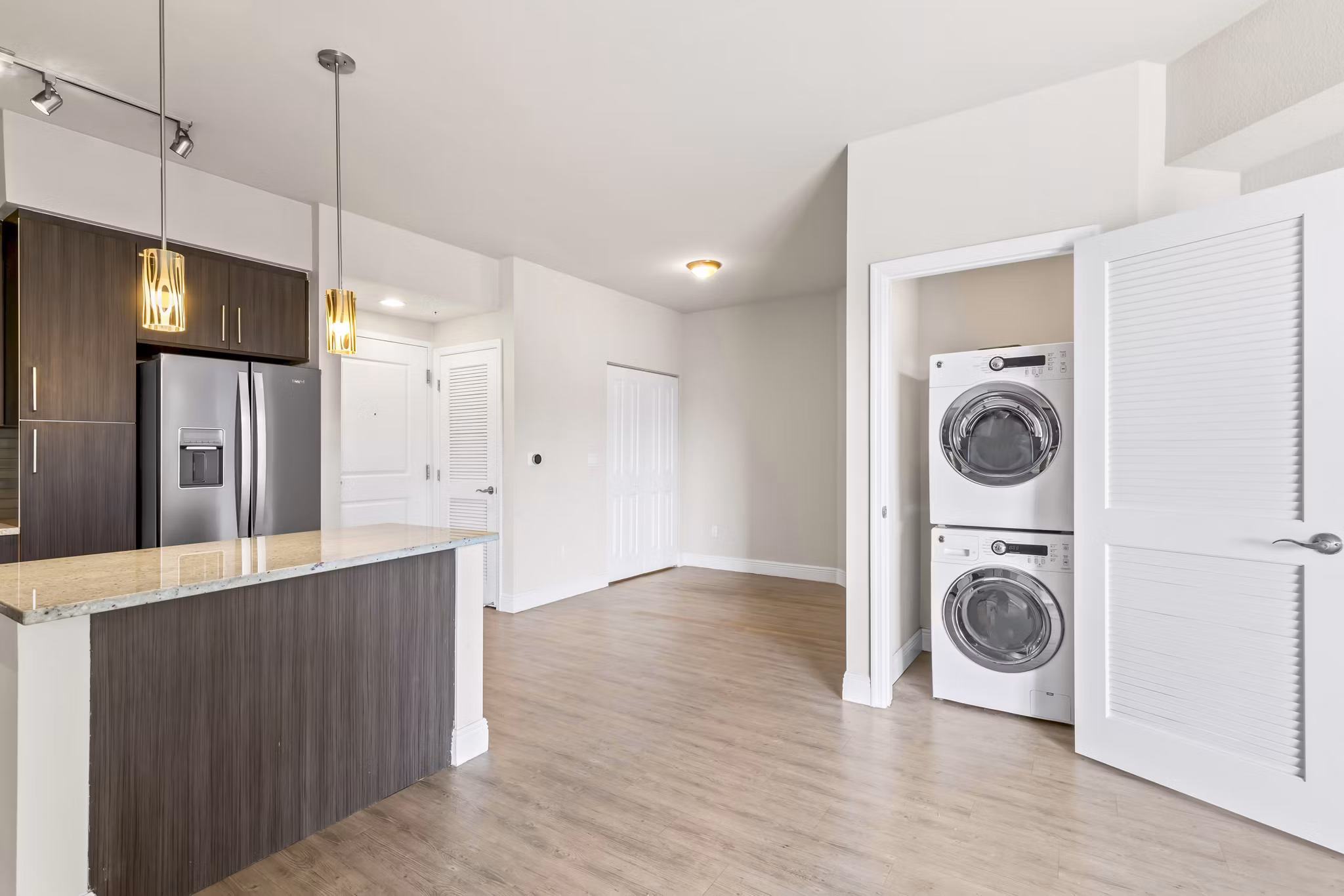 Modern laundry room with front-loading washers and dryers at SoMa at Brickell Apartments