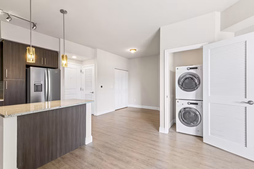 Modern laundry room with front-loading washers and dryers at SoMa at Brickell Apartments