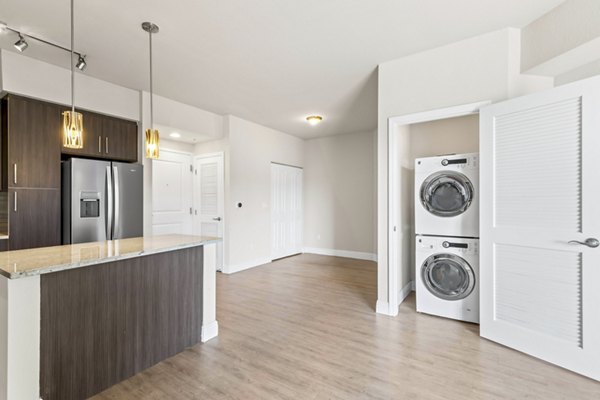 Modern laundry room with front-loading washers and dryers at SoMa at Brickell Apartments
