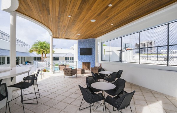 Courtyard at SoMa at Brickell Apartments featuring lush landscaping and cozy seating areas