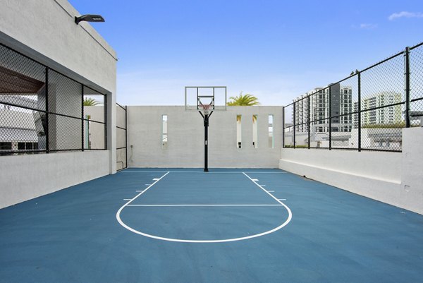 Sport court featuring basketball hoops at SoMa at Brickell Apartments