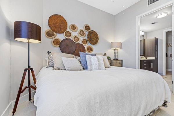 Boca City Walk Apartments: Cozy bedroom with modern decor and natural light, ideal for luxury living in an urban setting