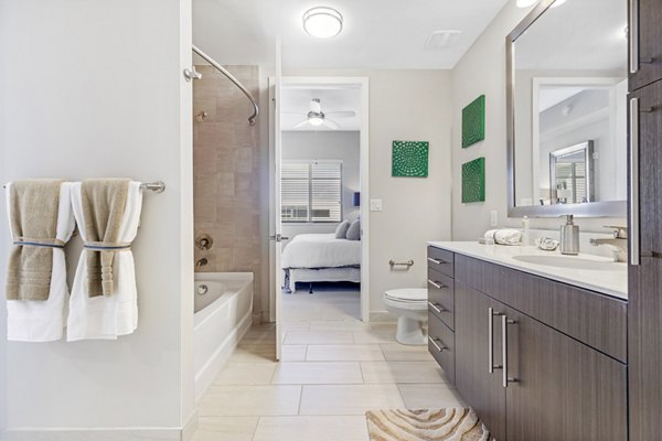Bathroom featuring modern fixtures and marble countertops at Boca City Walk Apartments