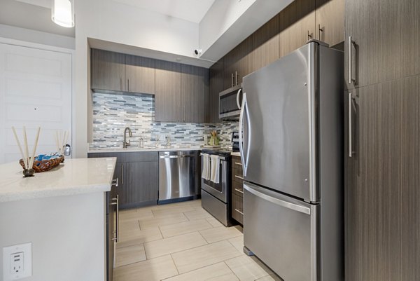 Modern kitchen with stainless steel appliances at Boca City Walk Apartments