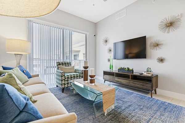 Modern living room with plush seating and contemporary decor at Boca City Walk Apartments