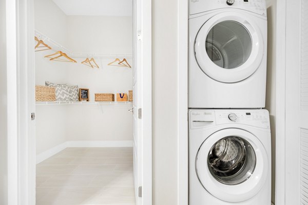 Laundry facilities with modern machines in Boca City Walk Apartments