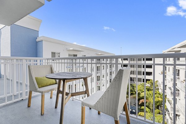 Boca City Walk Apartments: Spacious patio with modern furnishings and green views