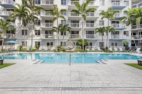 Inviting outdoor swimming pool area at Boca City Walk Apartments, designed for relaxing and leisure activities under the Florida sun