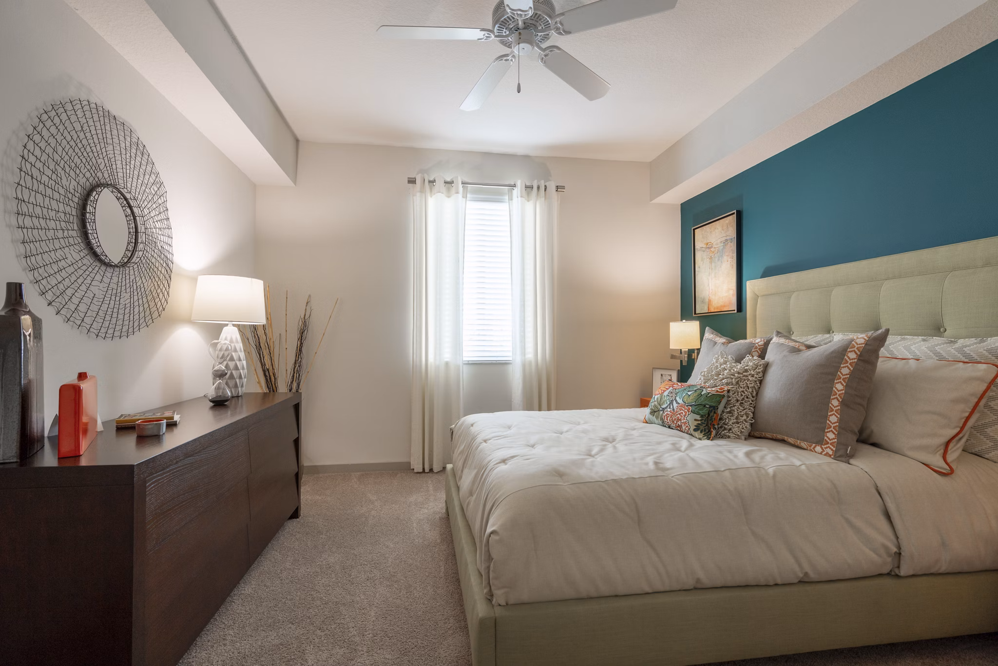 Modern bedroom with plush bedding and large windows at The Franklin Delray Apartments, offering luxurious living in Delray Beach