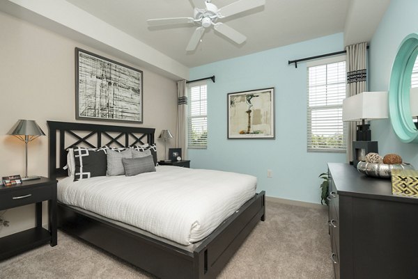 Bedroom featuring modern decor and queen bed at The Franklin Delray Apartments