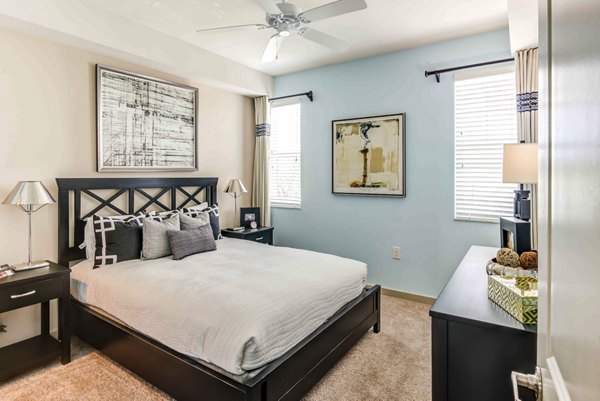 Cozy bedroom with elegant decor at The Franklin Delray Apartments, offering luxury living in a stylish, comfortable setting